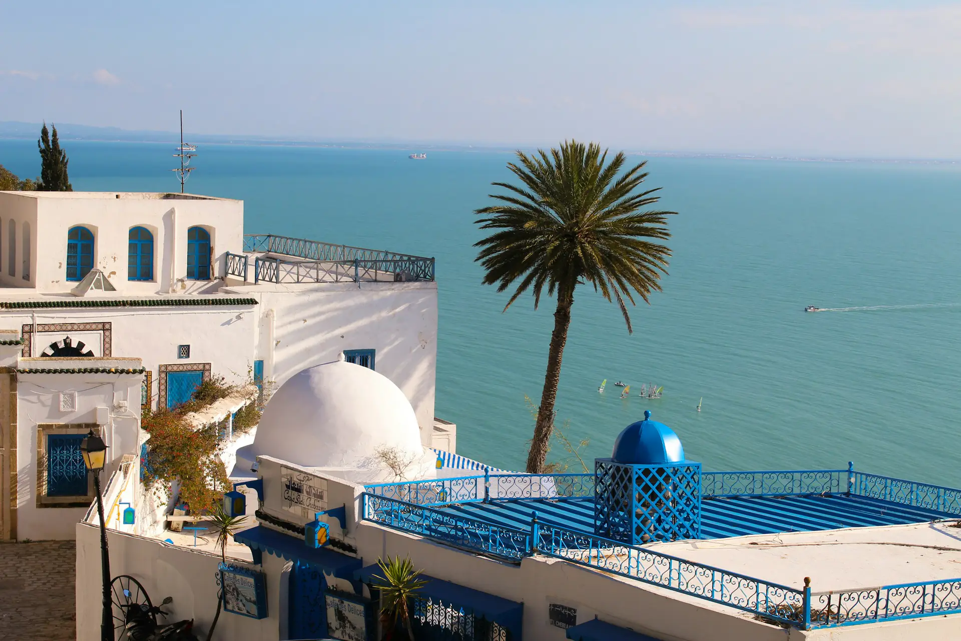 White domes and blue railings on a terrace in Sidi Bou Said, above the Gulf of Tunis